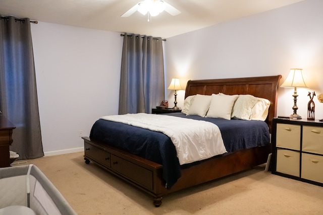 bedroom with ceiling fan, baseboards, and light carpet