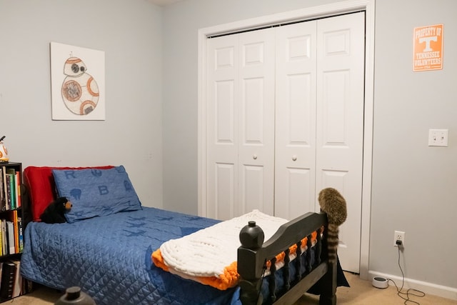 bedroom with a closet, carpet floors, and baseboards