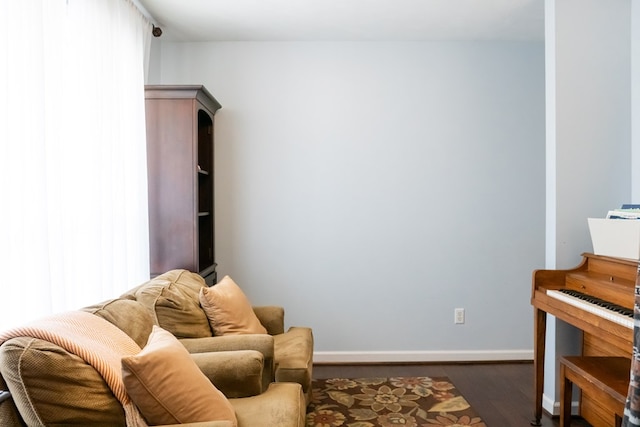 sitting room featuring baseboards and wood finished floors