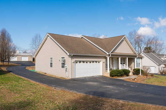 view of front of home with aphalt driveway, a porch, a shingled roof, and a garage