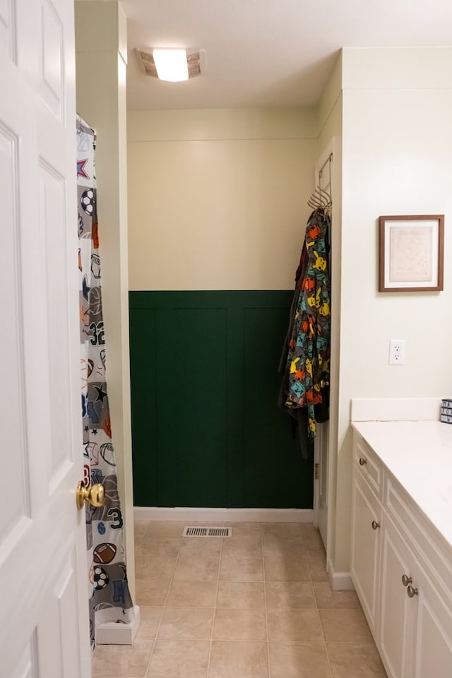 bathroom with tile patterned floors, visible vents, and vanity