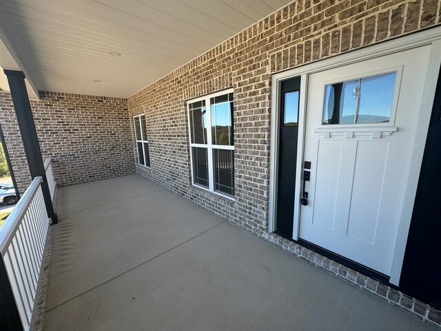 entrance to property with brick siding