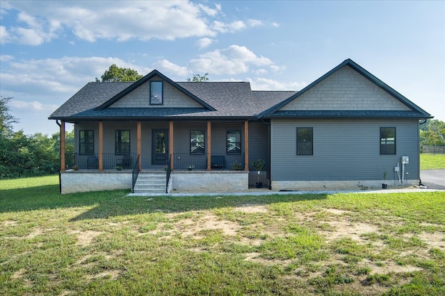 back of house featuring a porch, roof with shingles, and a lawn