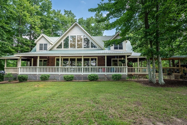 farmhouse-style home featuring metal roof, a porch, and a front yard