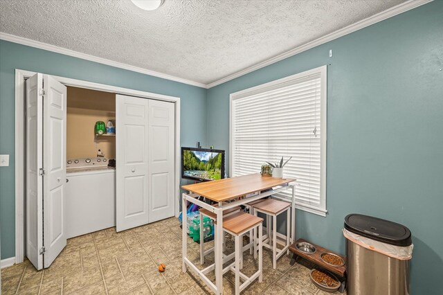 office with a textured ceiling, baseboards, washer / dryer, and crown molding