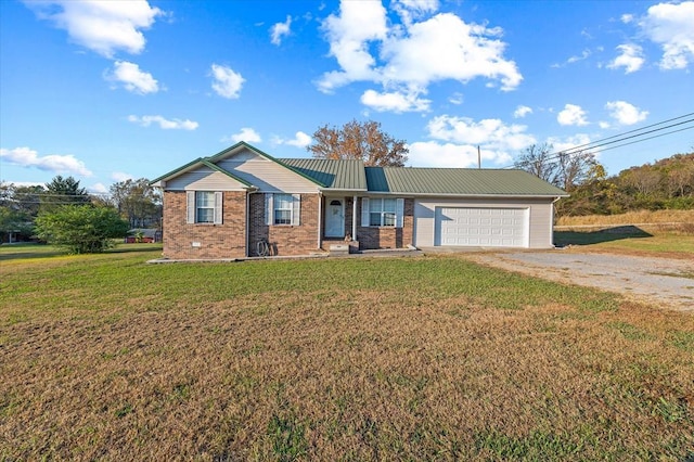 ranch-style home featuring dirt driveway, metal roof, an attached garage, a front lawn, and brick siding