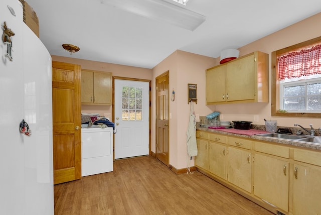 kitchen featuring light countertops, washer / clothes dryer, and light brown cabinets