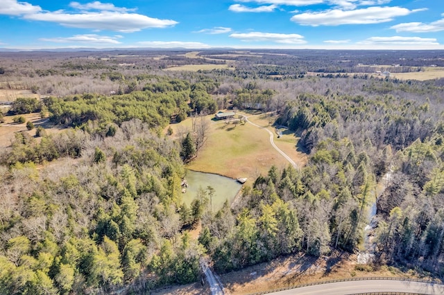 birds eye view of property with a view of trees