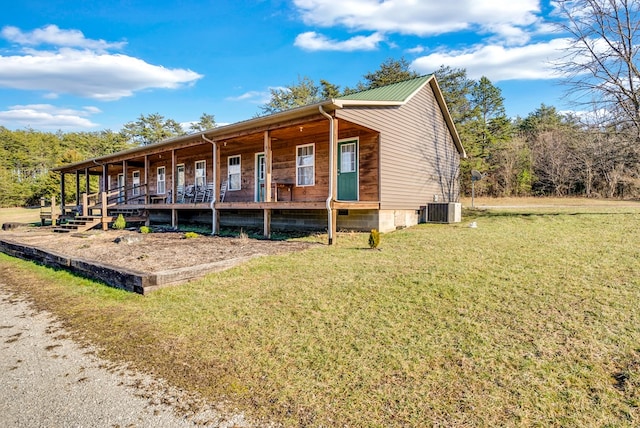 view of front facade featuring an outbuilding, metal roof, central AC unit, crawl space, and an exterior structure