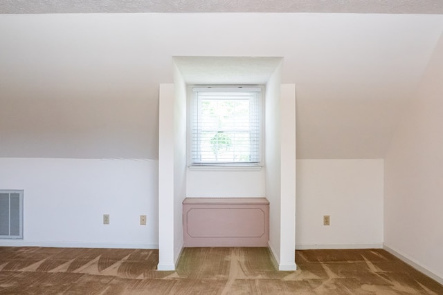 bonus room featuring baseboards, visible vents, and carpet flooring