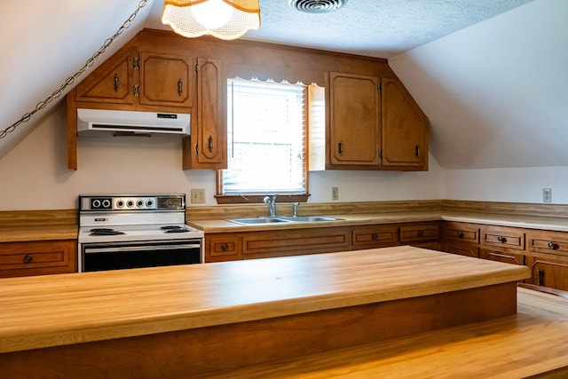 kitchen featuring light countertops, brown cabinetry, a sink, range with electric cooktop, and under cabinet range hood