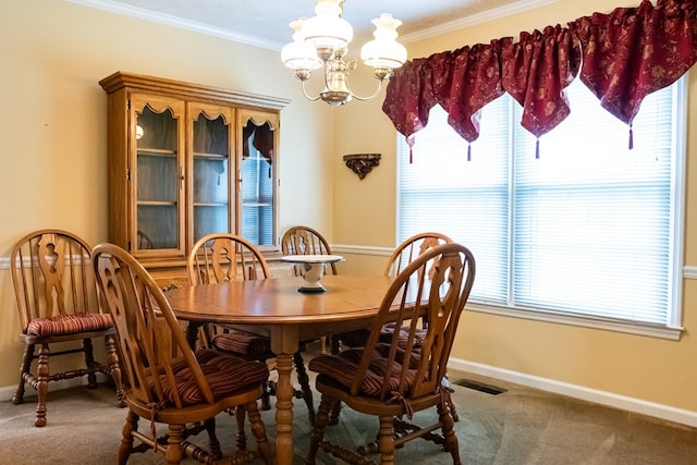 carpeted dining room with crown molding, visible vents, a notable chandelier, and baseboards