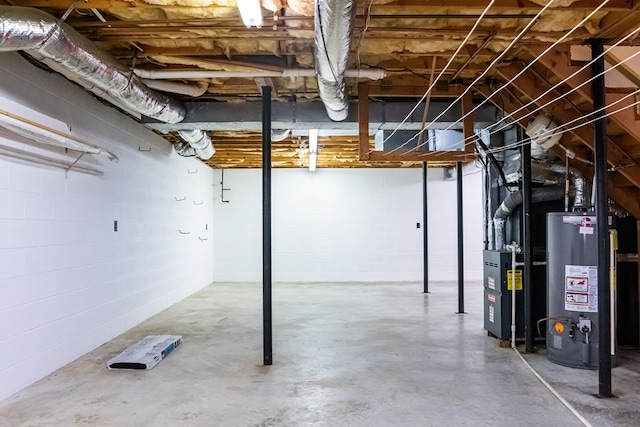 unfinished basement with water heater and heating unit