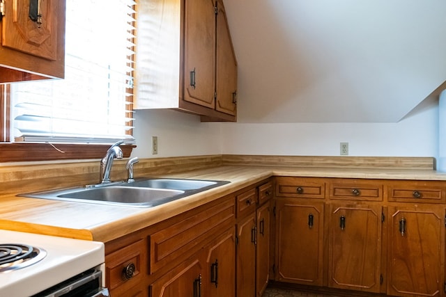 kitchen with brown cabinets, light countertops, and a sink