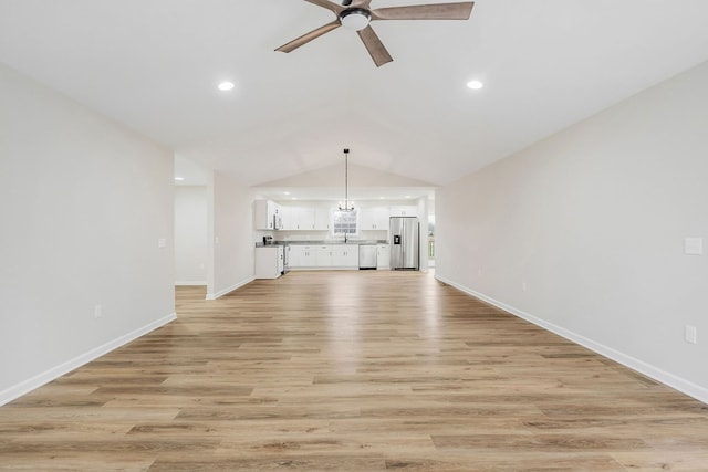 unfurnished living room with lofted ceiling, recessed lighting, light wood-style flooring, ceiling fan, and baseboards