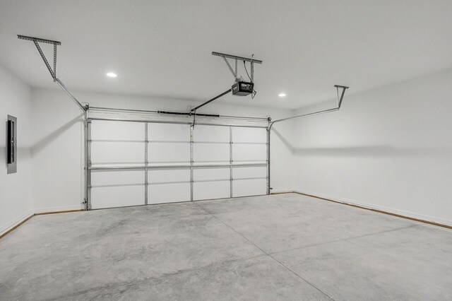 garage with a garage door opener and baseboards