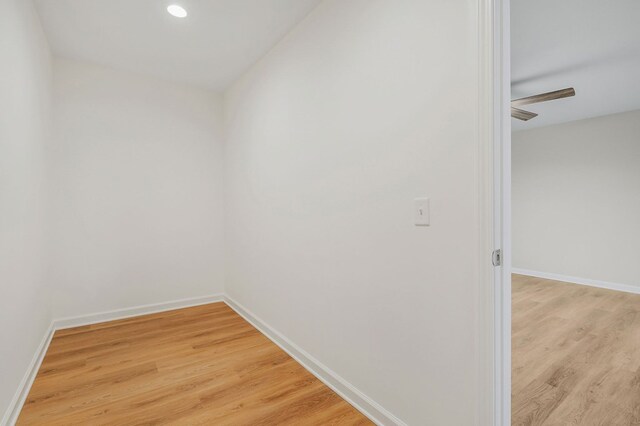 hall featuring light wood-style floors and baseboards