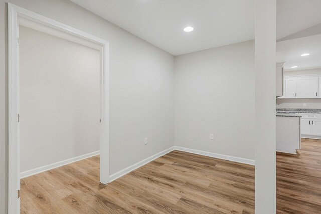 unfurnished dining area with light wood finished floors, baseboards, and recessed lighting