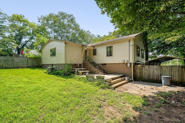 rear view of property featuring central AC, a yard, stairway, and fence