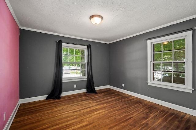 unfurnished room featuring dark wood-style floors, ornamental molding, a textured ceiling, and baseboards