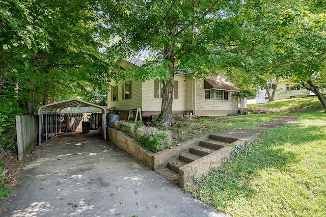 view of front of home with driveway, metal roof, and a carport