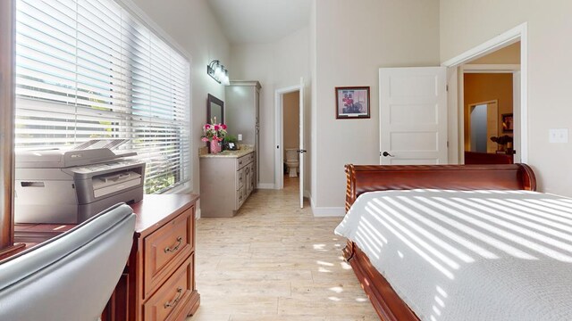 bedroom featuring baseboards and light wood-style floors