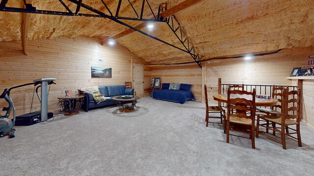 dining room with carpet floors, wood walls, and lofted ceiling with beams