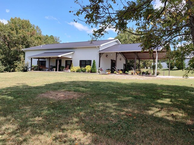 rear view of house with a carport and a lawn