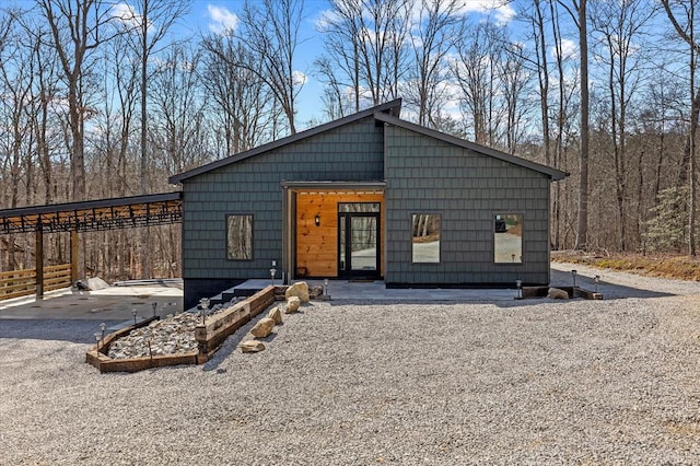 view of front facade with aphalt driveway and a carport