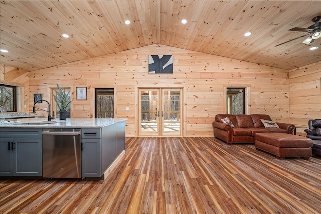 kitchen with french doors, gray cabinets, stainless steel dishwasher, open floor plan, and vaulted ceiling