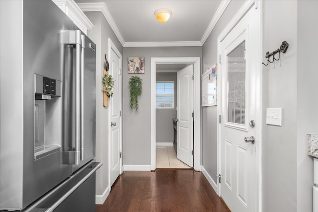 corridor featuring baseboards, dark wood-style flooring, and crown molding