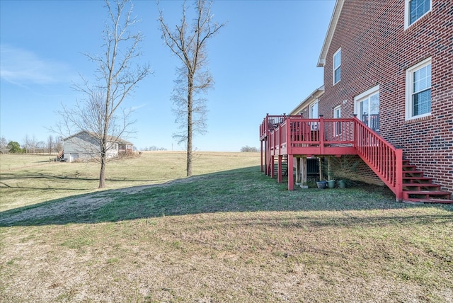 view of yard with stairway and a deck