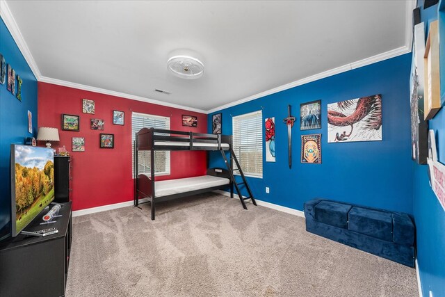 bedroom with carpet floors, visible vents, ornamental molding, and baseboards