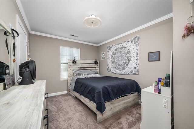 carpeted bedroom with ornamental molding, visible vents, and baseboards