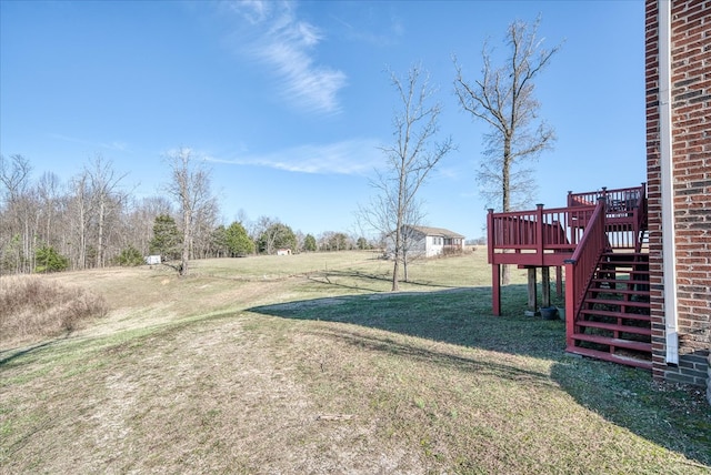 view of yard featuring a deck and stairway