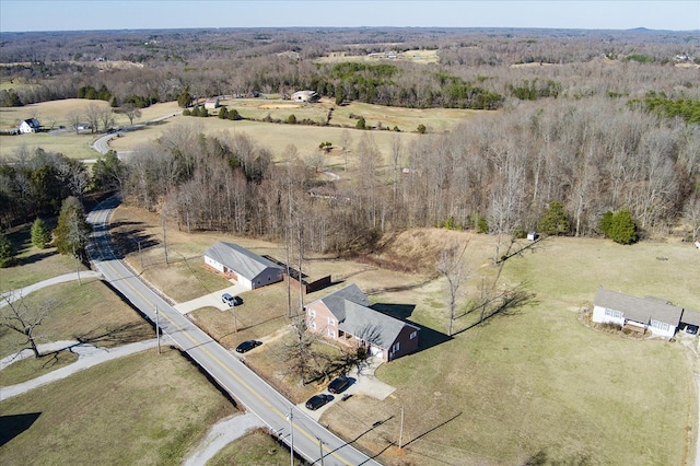 drone / aerial view featuring a rural view and a view of trees