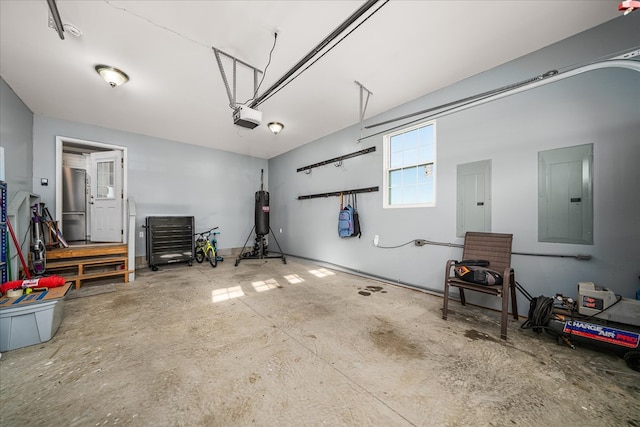 garage with electric panel, freestanding refrigerator, and a garage door opener