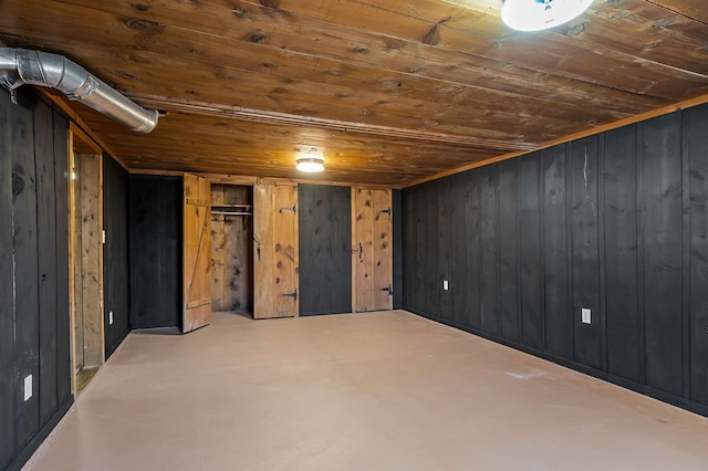 finished basement featuring wood ceiling and wooden walls