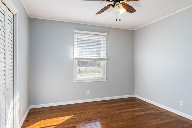 empty room with dark wood finished floors and baseboards