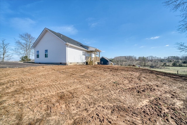 view of side of home featuring crawl space