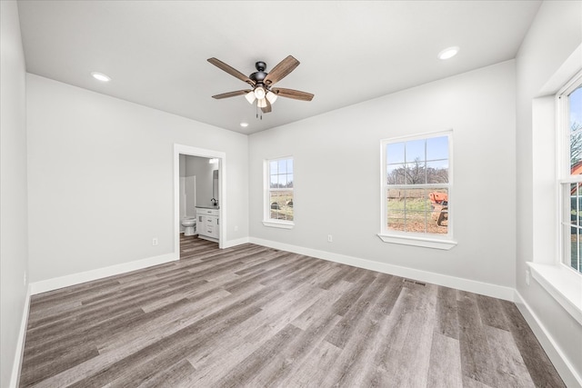 spare room featuring a ceiling fan, recessed lighting, baseboards, and wood finished floors