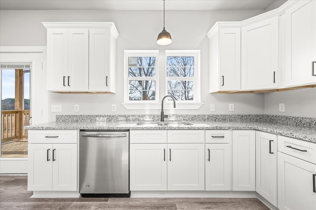 kitchen with light stone counters, pendant lighting, white cabinets, and stainless steel dishwasher