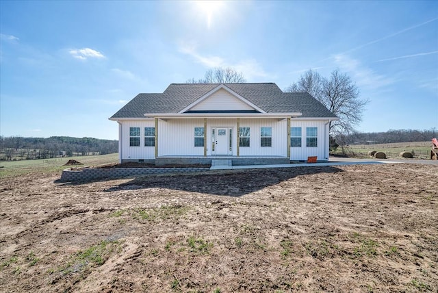 view of front facade with crawl space and roof with shingles