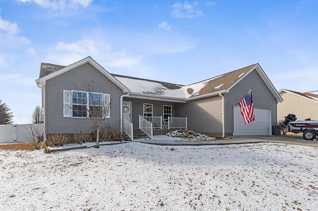 single story home with a porch and a garage