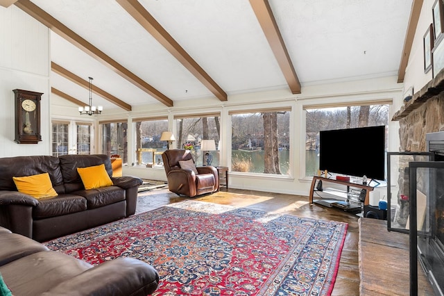 living area featuring lofted ceiling with beams and a chandelier