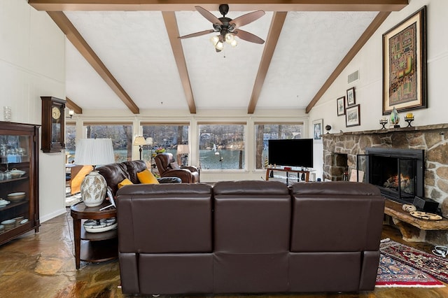 living area featuring lofted ceiling with beams, ceiling fan, a fireplace, and visible vents