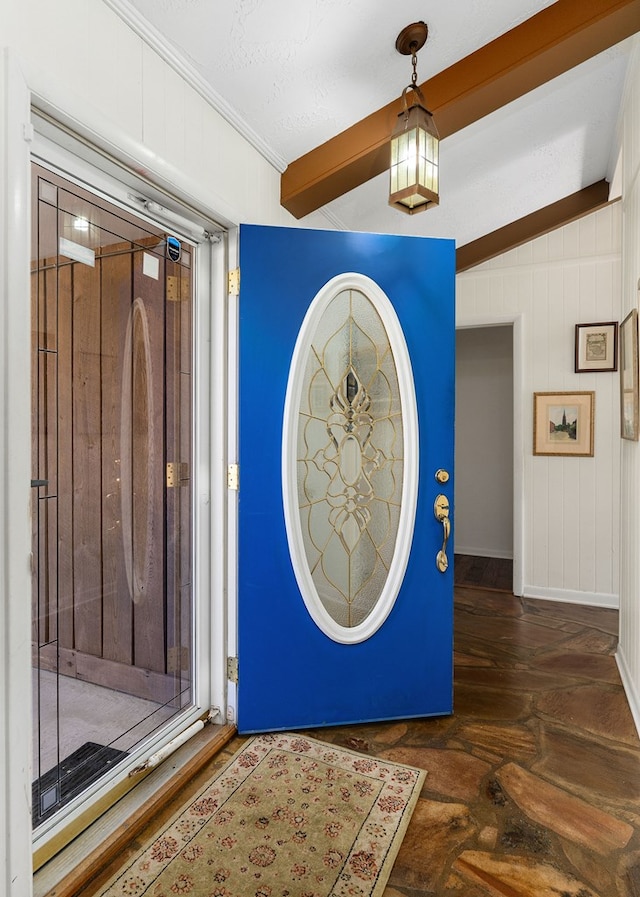 foyer entrance featuring baseboards and crown molding