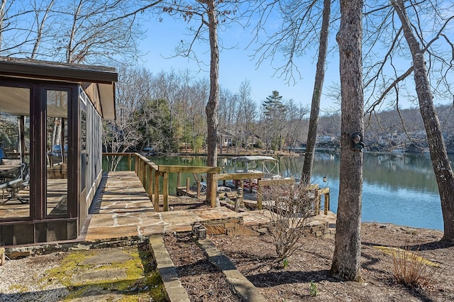 view of yard with a dock and a water view