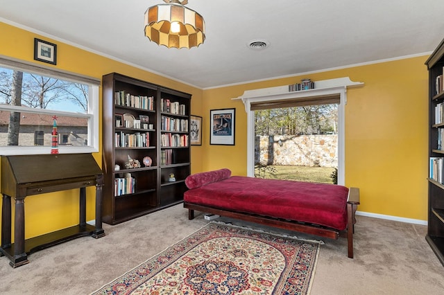 sitting room with baseboards, carpet, visible vents, and crown molding