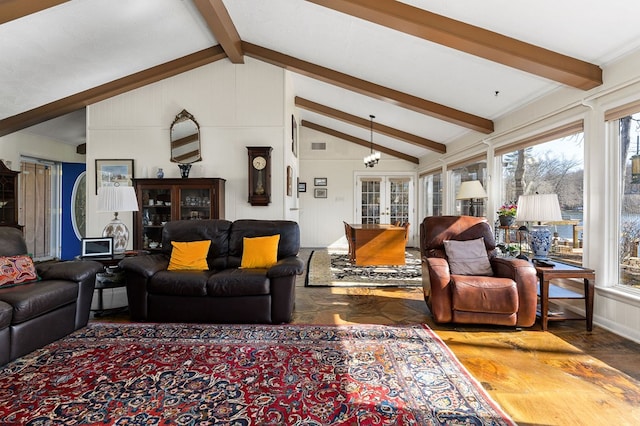 living room featuring lofted ceiling with beams and french doors